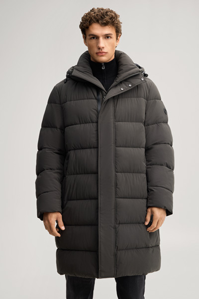 Leads to product detail page "Quilted coat in dark green"