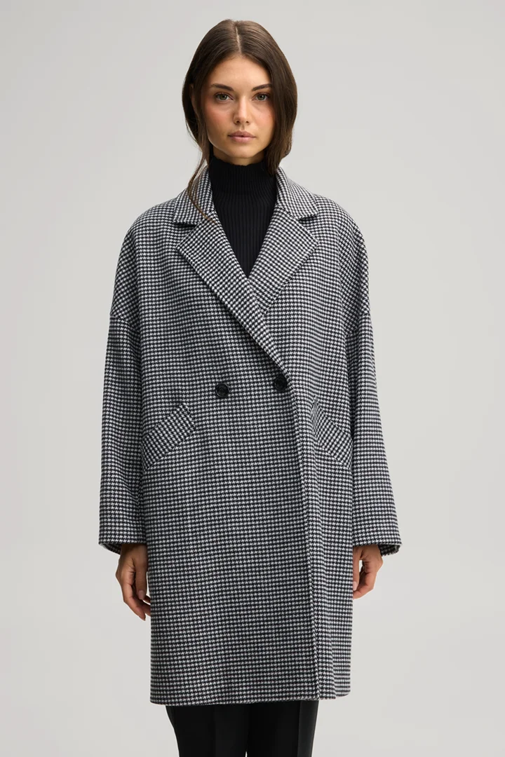 Leads to product detail page "Wool-blend coat in black and ecru with a pattern"