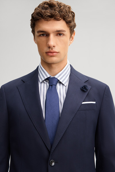 Leads to product detail page "Navy wool-blend suit"