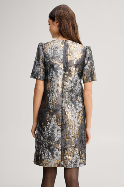 Leads to product detail page "Dress with puff sleeves in black, gold and silver pattern"
