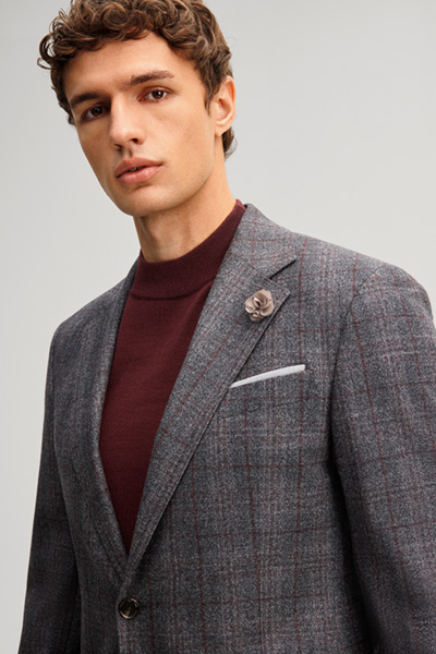 Leads to product detail page "A suit made from virgin wool in an anthracite chequered pattern"