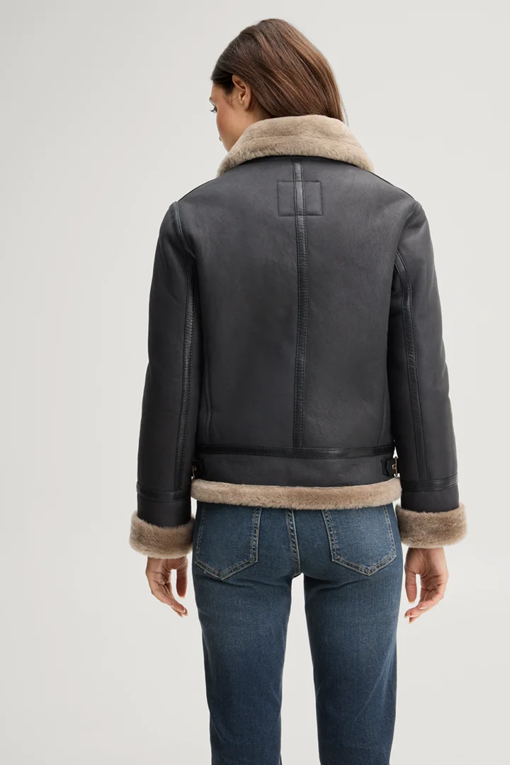 Leads to product detail page "Black lambskin biker jacket with beige fur"
