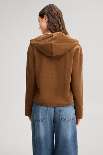 Leads to product detail page "Light brown corduroy blouse with a hood"