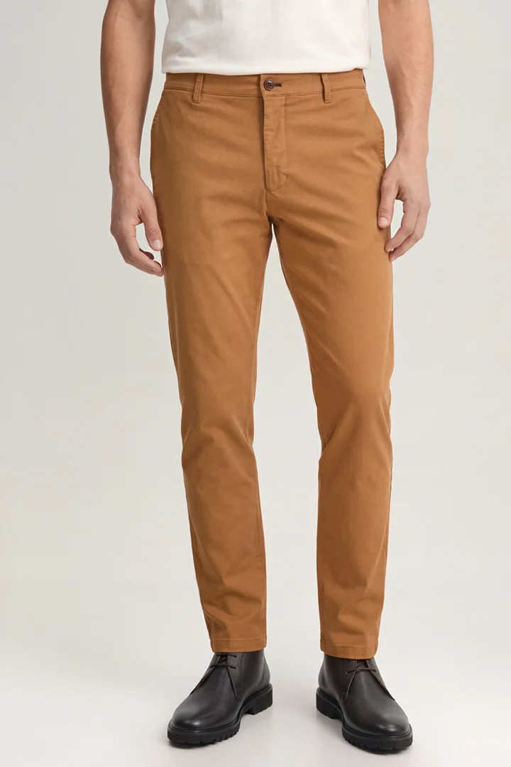 Leads to product detail page "Cognac-coloured chinos"
