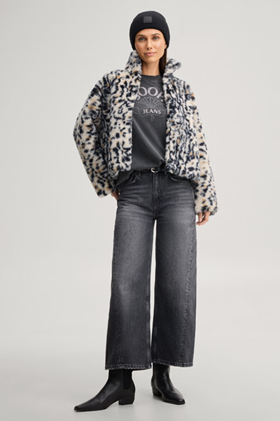 Leads to product detail page "Faux fur jacket with a stand-up collar in a beige and black pattern"