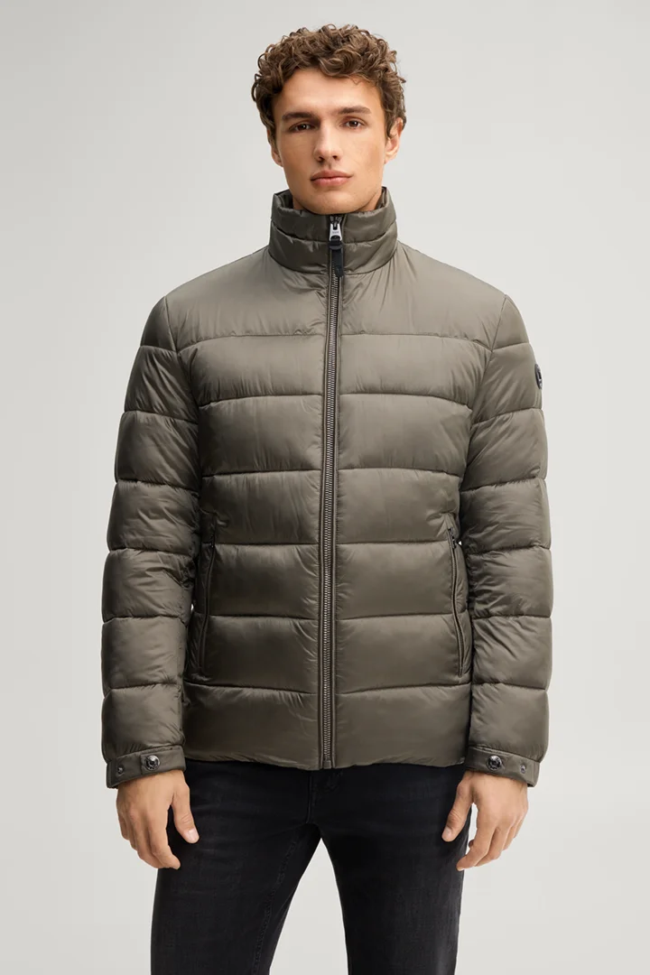 Leads to product detail page "Quilted jacket with a stand-up collar in dark green"