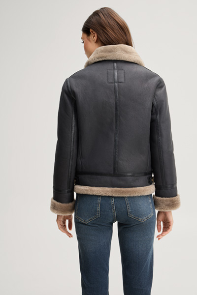 Leads to product detail page "Black lambskin biker jacket with beige fur"