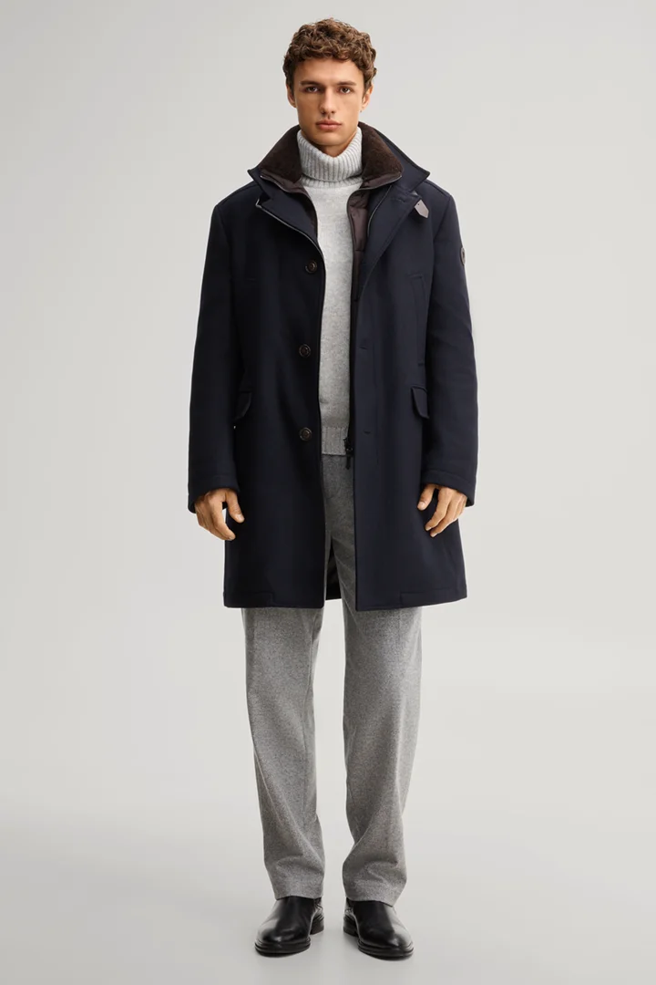 Leads to product detail page "Dark blue wool-blend coat with a stand-up collar"
