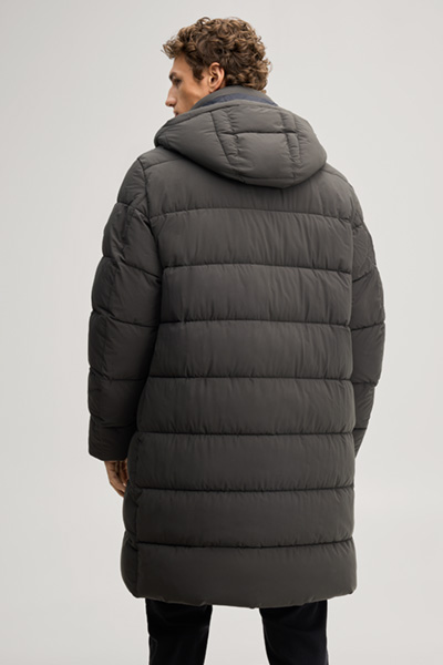 Leads to product detail page "Quilted coat in dark green"