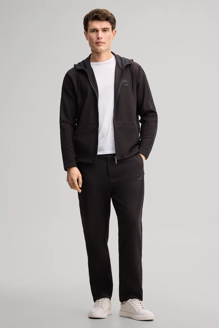 Leads to product detail page "Black tracksuit bottoms"