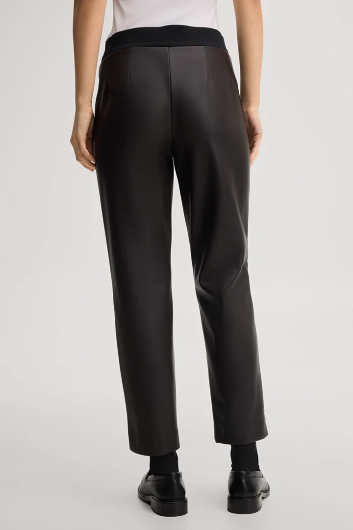 Leads to product detail page "Faux leather cigarette trousers in dark brown"
