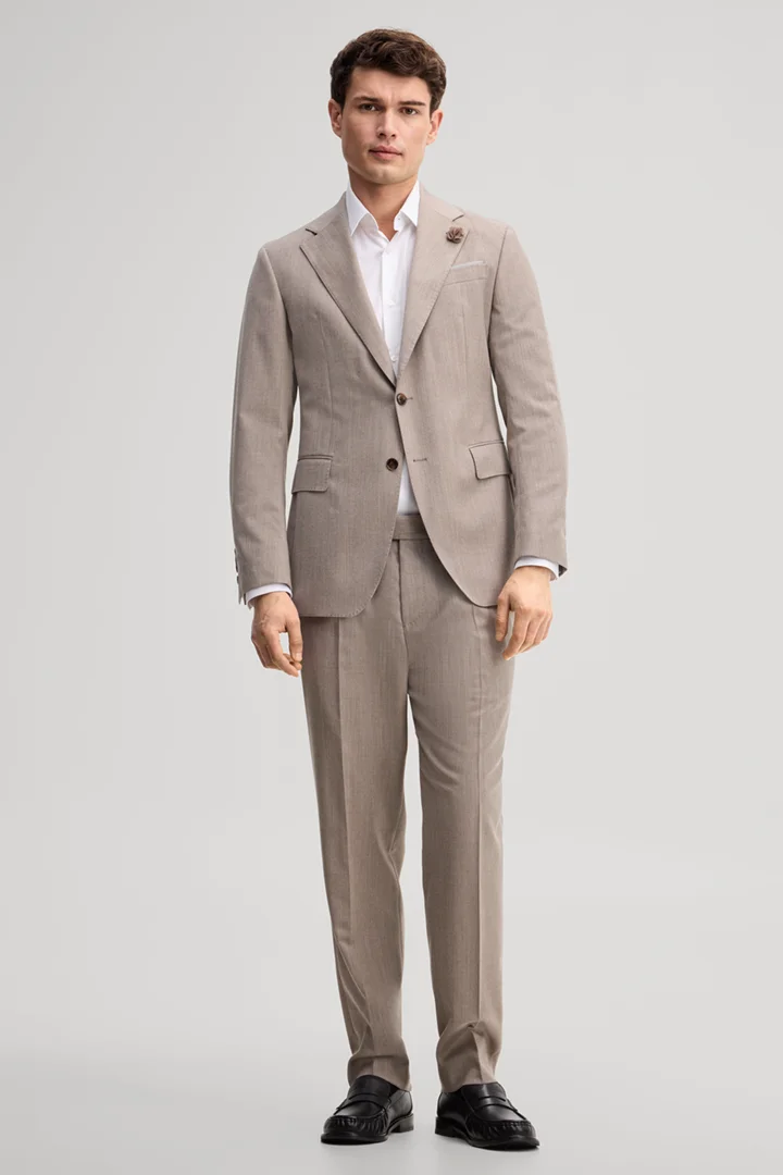 Leads to product detail page "Modular trousers made from virgin wool in light beige"
