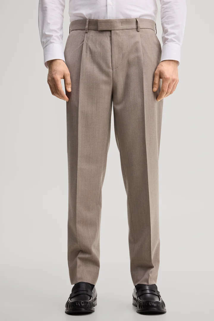 Leads to product detail page "Modular trousers made from virgin wool in light beige"