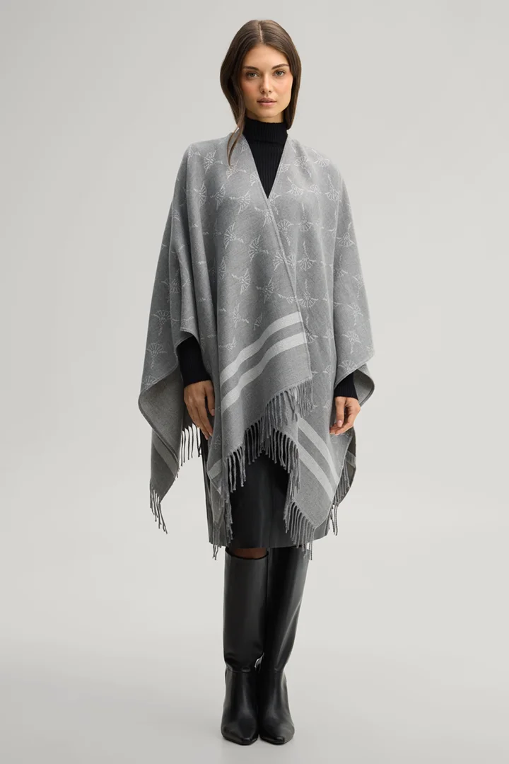 Leads to product detail page "Cornflower poncho in grey and ecru pattern"