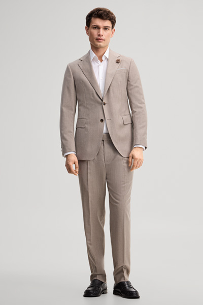 Leads to product detail page "Modular trousers made from virgin wool in light beige"