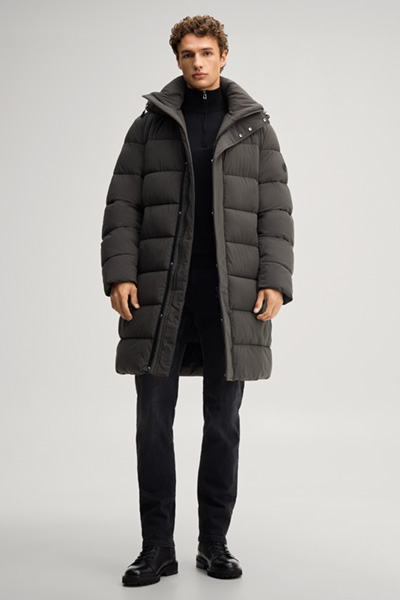 Leads to product detail page "Quilted coat in dark green"