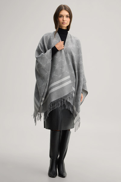 Leads to product detail page "Cornflower poncho in grey and ecru pattern"