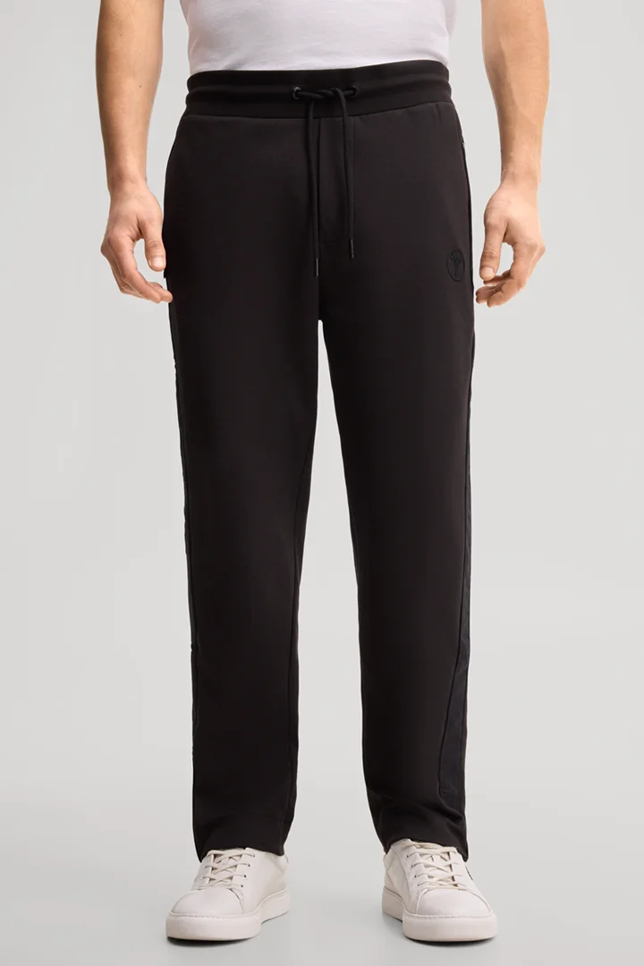 Leads to product detail page "Black tracksuit bottoms"