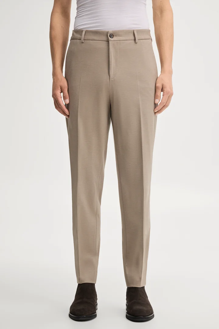 Leads to product detail page "Modular trousers in beige"