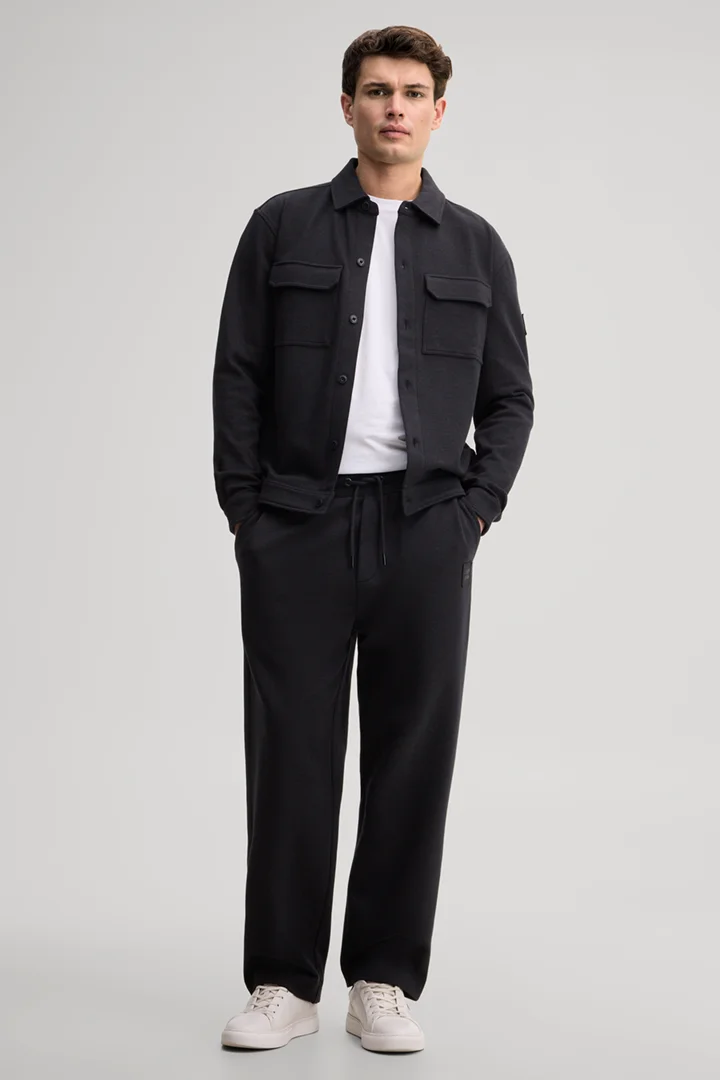 Leads to product detail page "Black tracksuit bottoms"