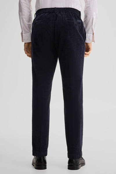 Leads to product detail page "Pleated trousers in navy"