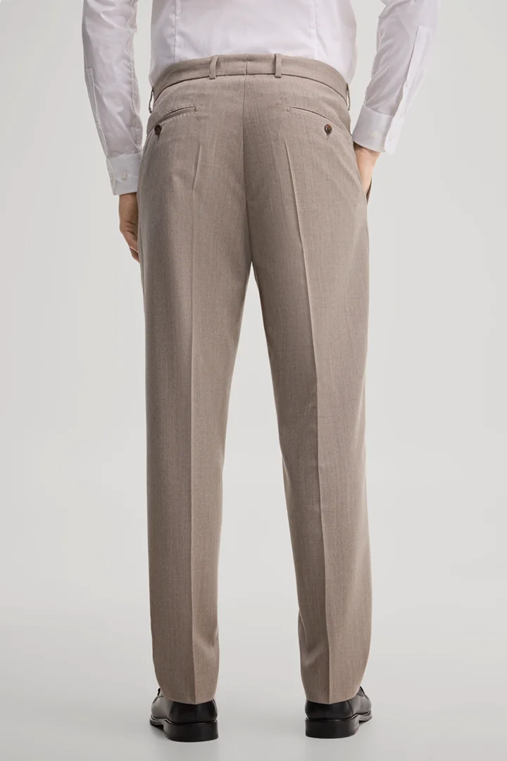 Leads to product detail page "Modular trousers made from virgin wool in light beige"