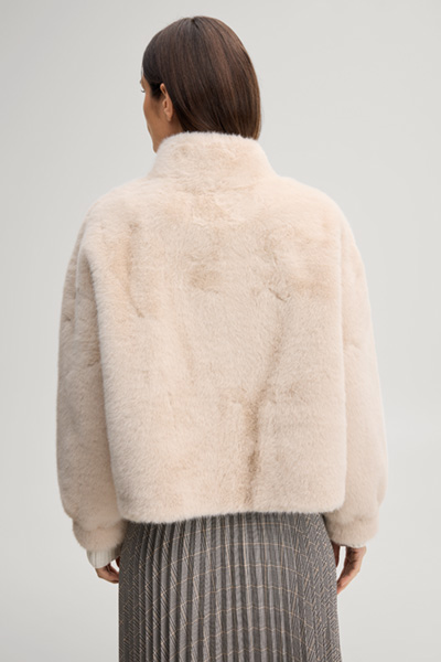 Leads to product detail page "Faux fur jacket with a stand-up collar in ecru"