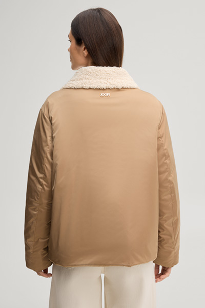 Leads to product detail page "Camel-coloured pilot jacket with teddy collar"