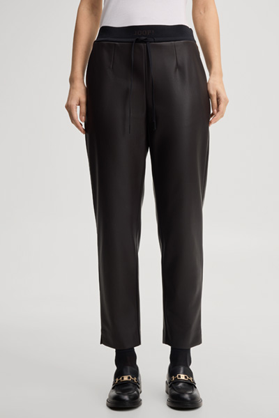 Leads to product detail page "Faux leather cigarette trousers in dark brown"
