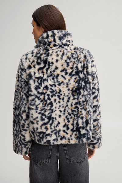 Leads to product detail page "Faux fur jacket with a stand-up collar in a beige and black pattern"