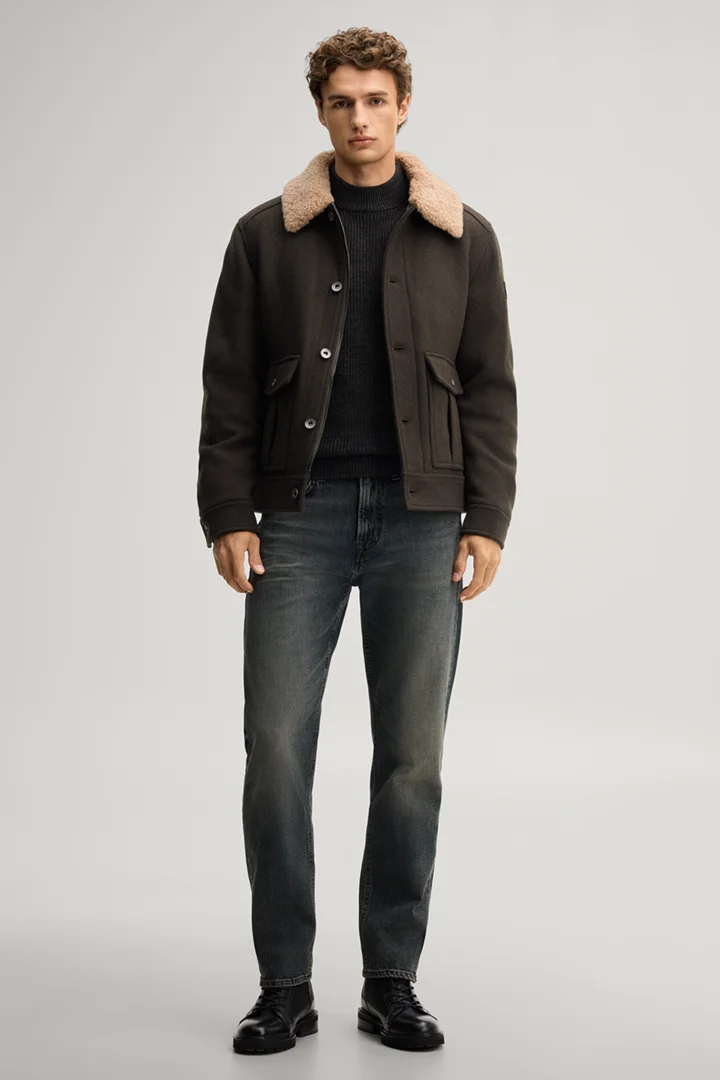 Leads to product detail page "Dark green jumper with a stand-up collar"