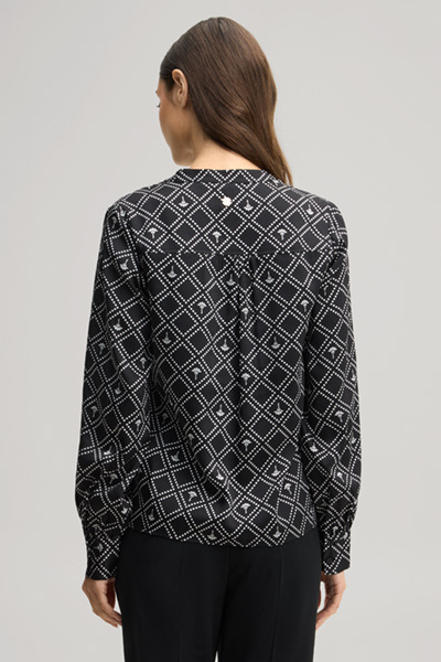 Leads to product detail page "Cornflower blouse in black and ecru pattern"