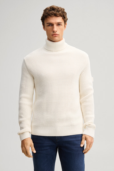 Leads to product detail page "Beige turtleneck jumper"