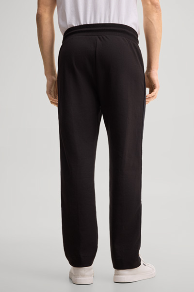 Leads to product detail page "Black tracksuit bottoms"