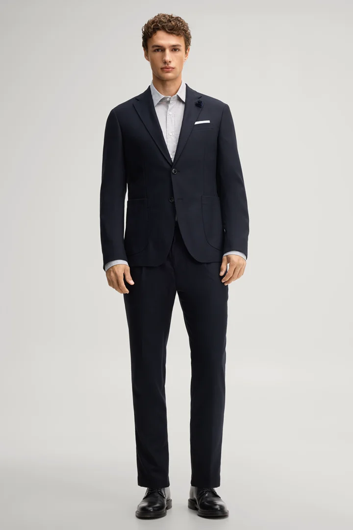 Leads to product detail page "Navy pleated trousers"