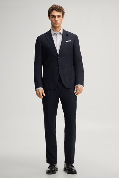 Leads to product detail page "Navy pleated trousers"