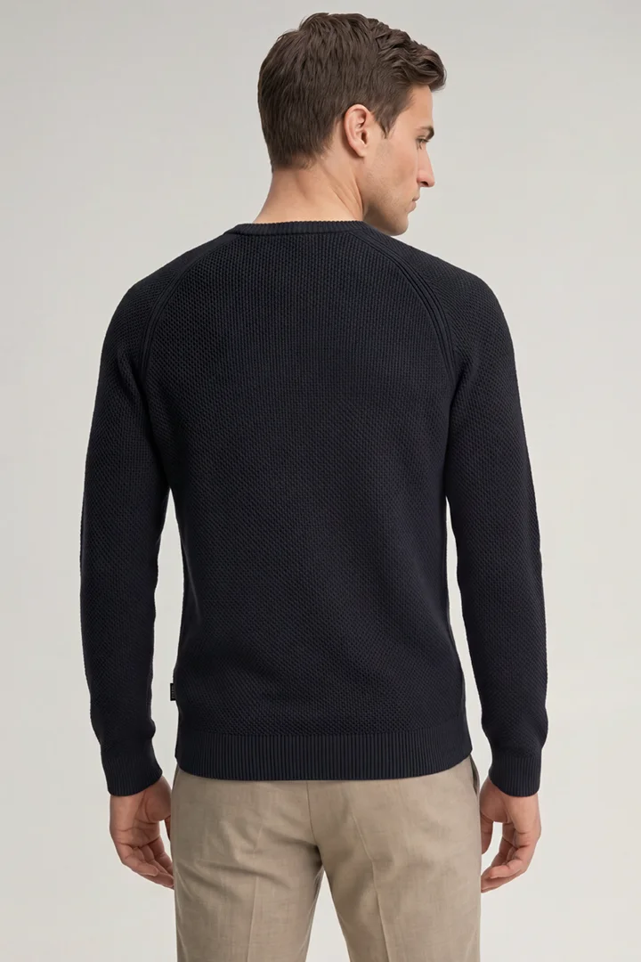 Leads to product detail page "Navy cotton crew-neck jumper"