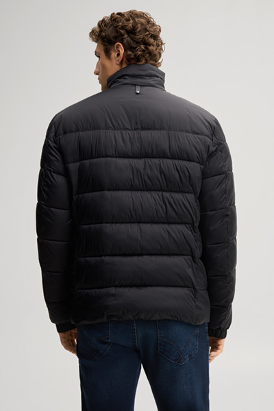 Leads to product detail page "Black quilted jacket with a stand-up collar"