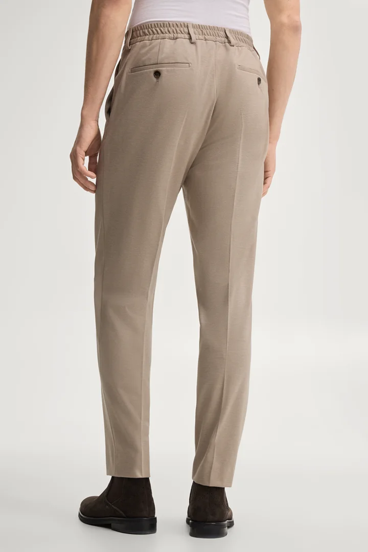 Leads to product detail page "Modular trousers in beige"