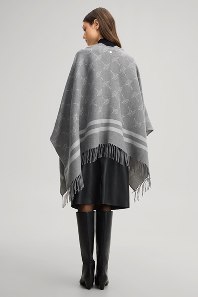 Leads to product detail page "Cornflower poncho in grey and ecru pattern"