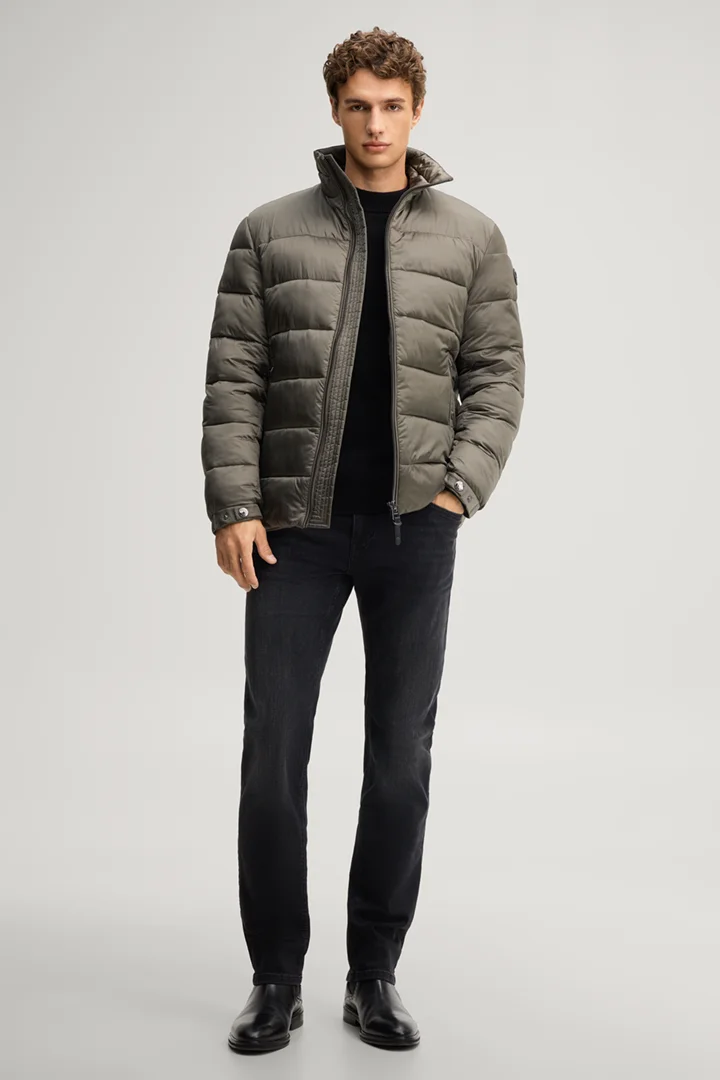 Leads to product detail page "Quilted jacket with a stand-up collar in dark green"