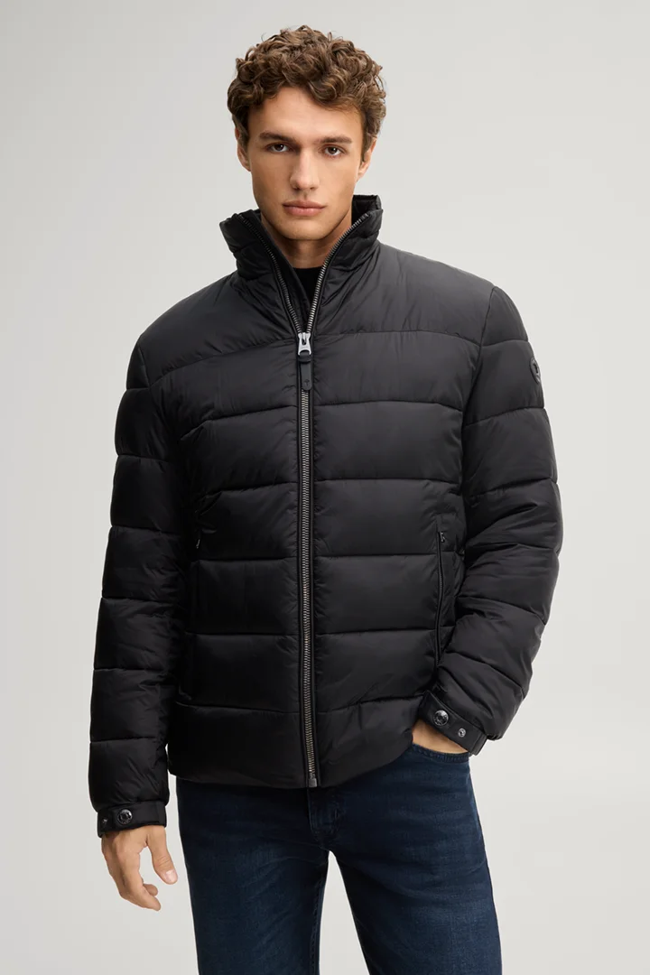 Leads to product detail page "Black quilted jacket with a stand-up collar"