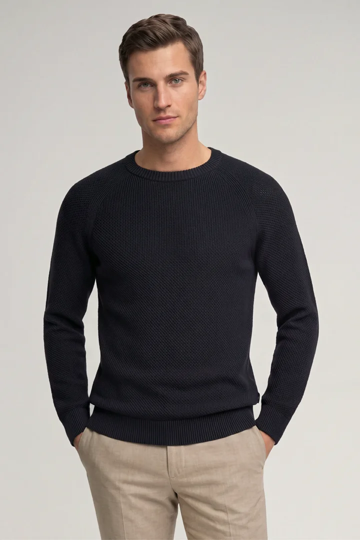 Leads to product detail page "Navy cotton crew-neck jumper"