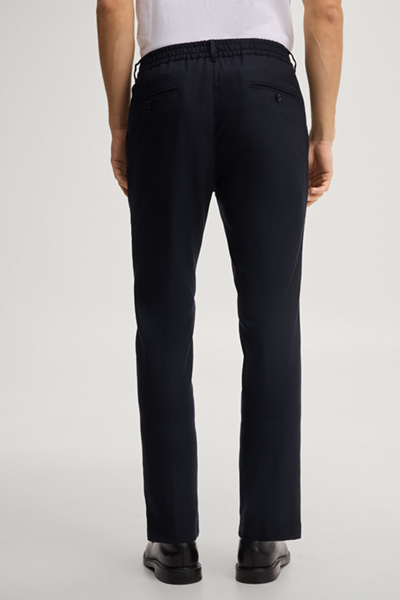 Leads to product detail page "Navy pleated trousers"