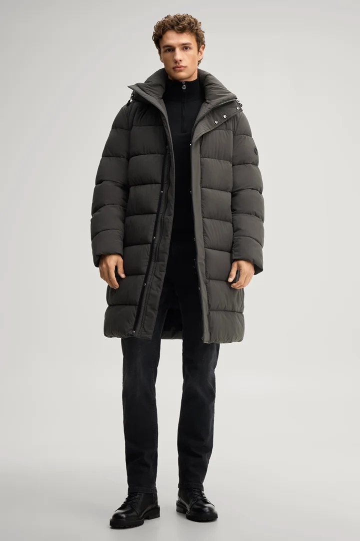 Leads to product detail page "Quilted coat in dark green"