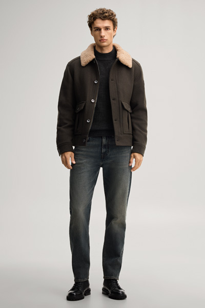 Leads to product detail page "Dark green jumper with a stand-up collar"