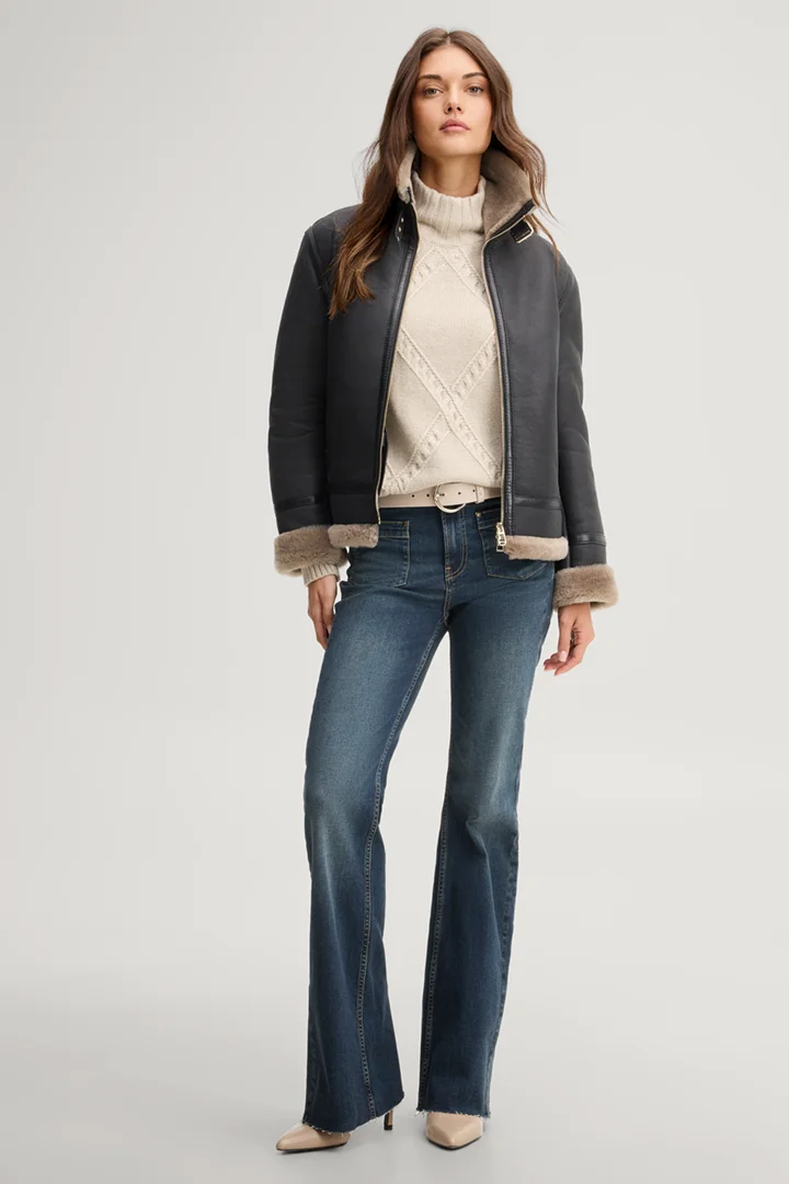 Leads to product detail page "Black lambskin biker jacket with beige fur"