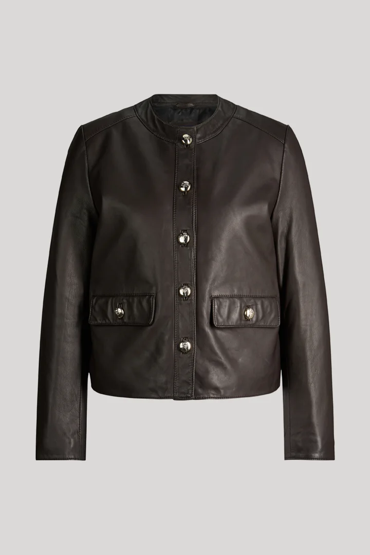 Leads to product detail page "Dark brown leather jacket with press studs"