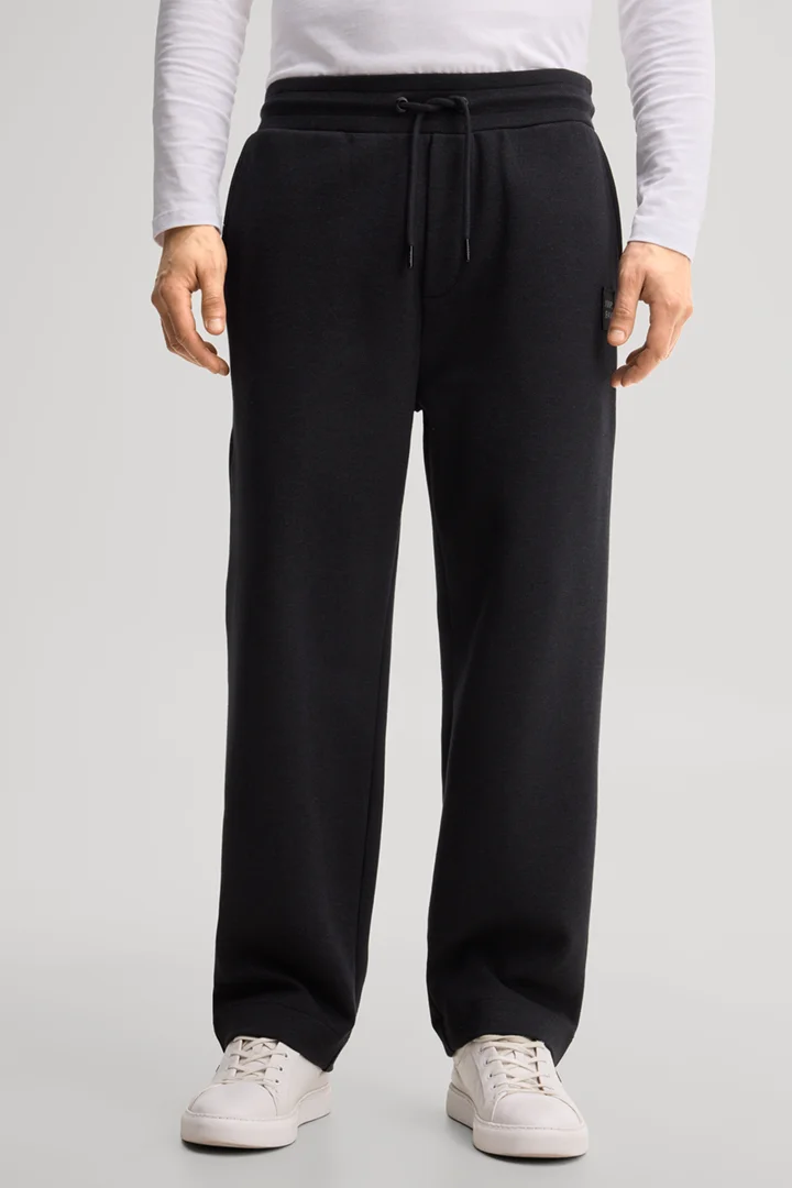 Leads to product detail page "Black tracksuit bottoms"