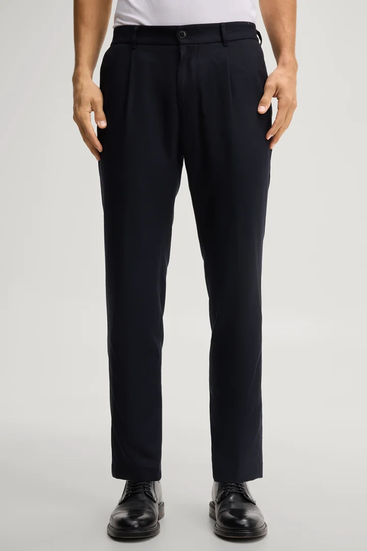Leads to product detail page "Navy pleated trousers"